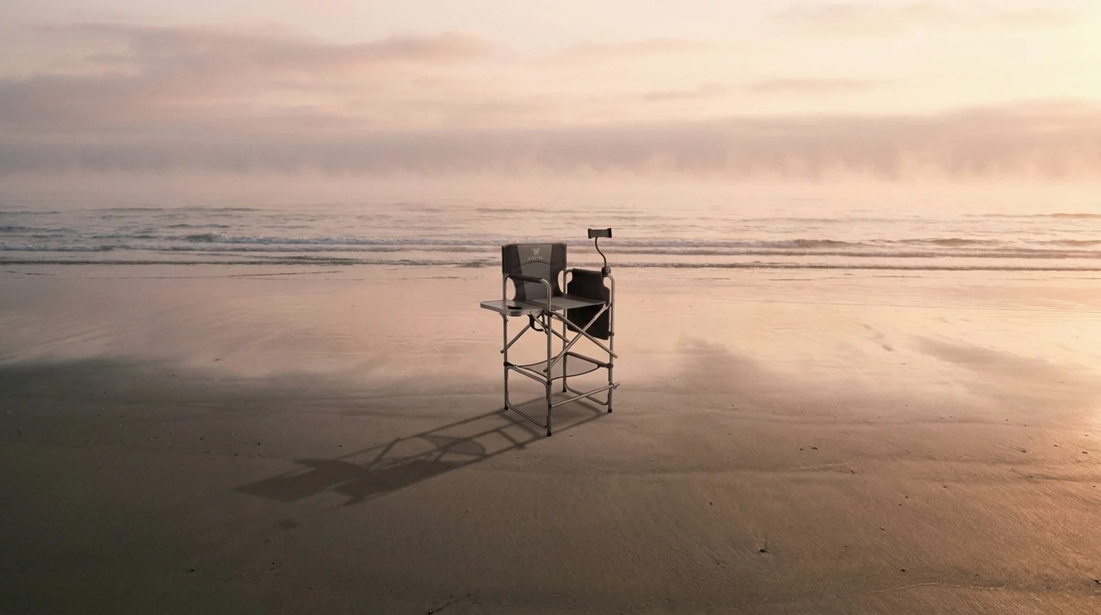 LAVIAR tall camping chair for adults set up alone at dawn in the desert, showing the high seat and footrest bar